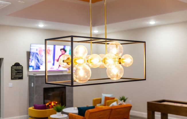 a chandelier with globes hanging from a ceiling in a living room