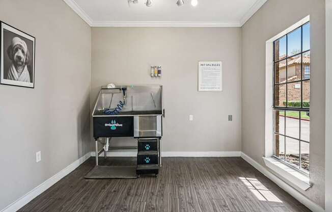 A room with a window and a piece of paper on the wall.