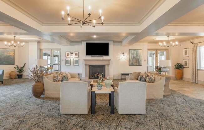 A living room with a fireplace and a large chandelier.