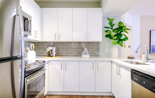 Kitchen with custom white cabinetry and stainless appliances at Sophia at Abacoa luxury Jupiter, FL apartments