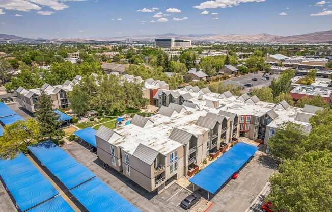 A bird's eye view of a residential area with houses and a swimming pool.