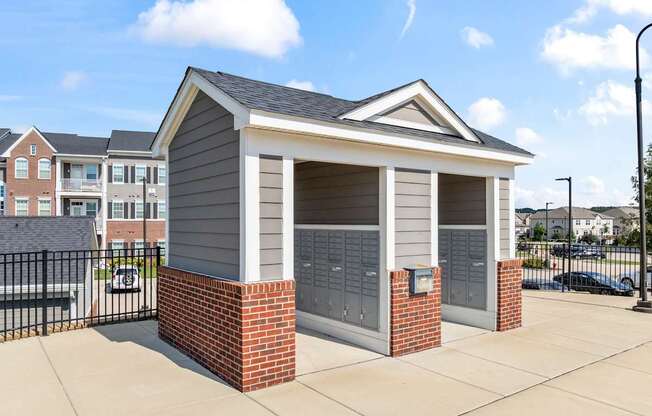 A small building with a grey roof and brick pillars.