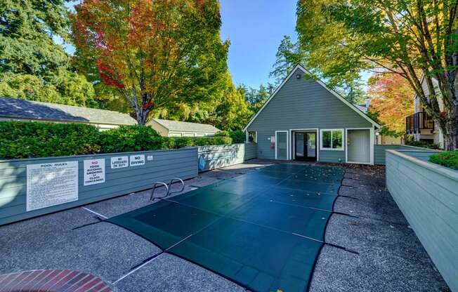 a backyard with a tennis court and a house