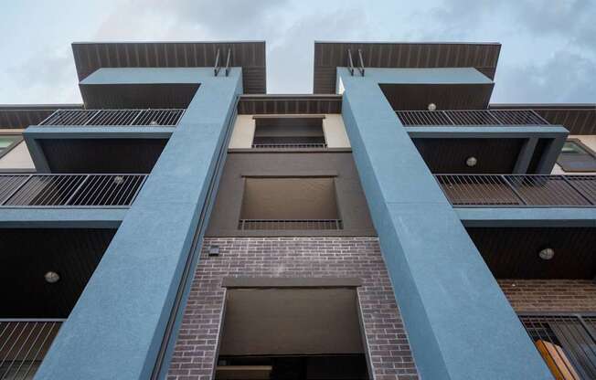 A tall building with a blue railing.