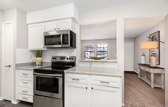 Renovated Kitchen with White Tile Backsplash and Stainless Steel Appliances