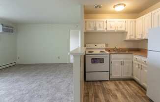 This is a photo of the kitchen and living room in the 545 square foot 1 bedroom, 1 bath apartment at Lisa Ridge Apartments in the Westwood neighborhood of Cincinnati, Ohio.