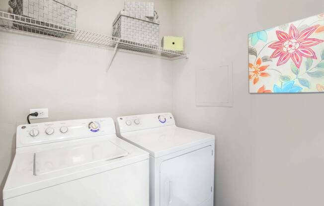 the washer dryer closet inside of an apartment at Seasons at Umstead apartments in Raleigh