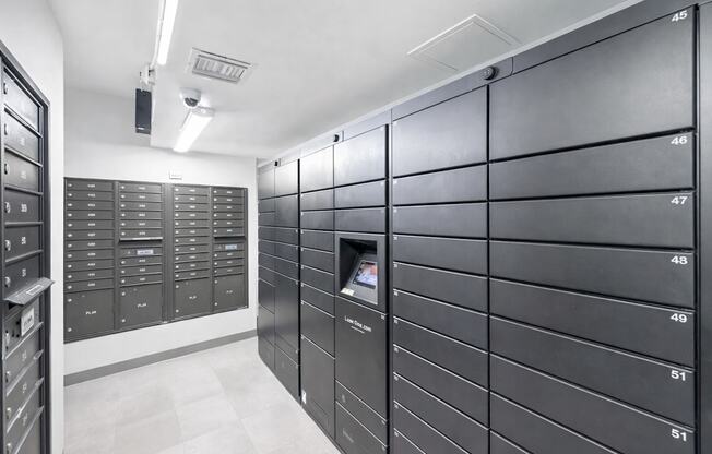 A row of mailboxes are lined up against a wall.