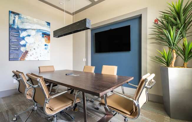 a conference room with a table and chairs