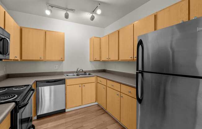 a kitchen with stainless steel appliances and wooden cabinets