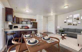 a living room with a dining room table and a kitchen
