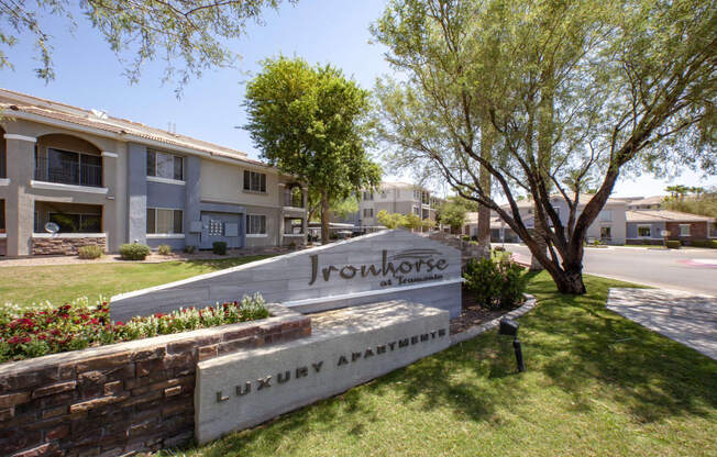 Apartments in North Phoenix AZ for Rent - Exterior View of Ironhorse at Tramonto Apartments Building Showcasing Entrance Sign and Expansive Community