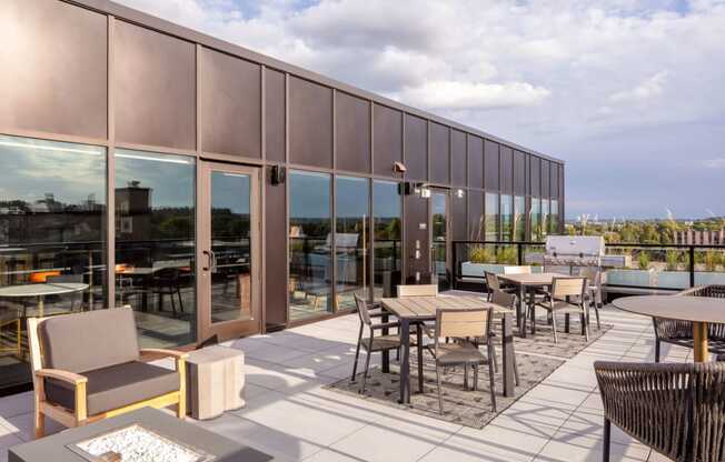 a patio with tables and chairs on the roof of a building at Maven on Broadway, Minnesota