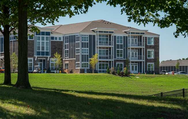 a large apartment building on a green lawn