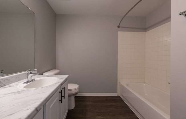 an empty bathroom with a sink toilet and bath tub