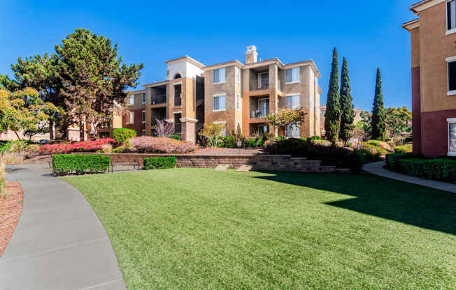 A building with a well-maintained lawn in front.