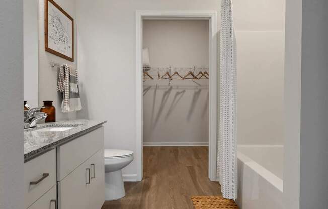 A bathroom with a toilet, sink, and bathtub.