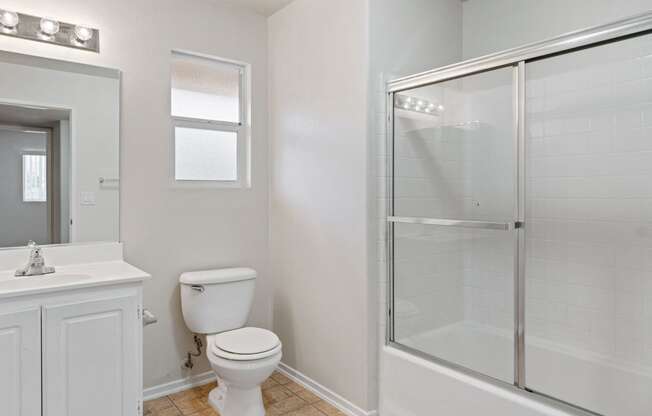 an empty bathroom with a shower toilet and sink at Dronfield Astoria, 13140 Dronfield Ave