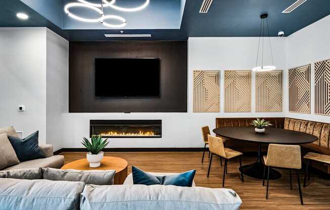 A modern living room with a fireplace and a television.