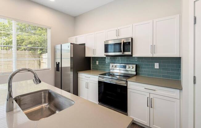 Model kitchen with glass tile backsplash