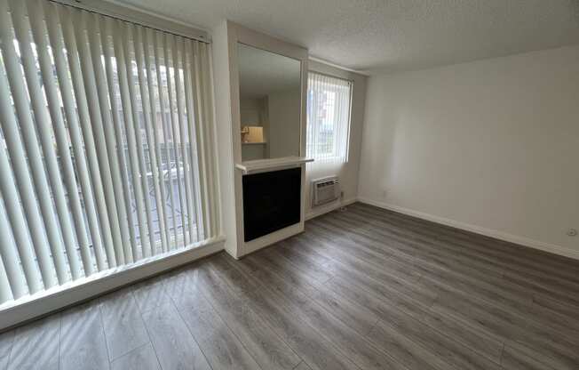 Living Room with Hardwood Floors, Fireplace and Patio Doors