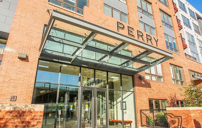 a large brick building with a large glass entrance