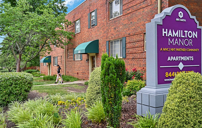 a brick building with a sign apartments at Hamilton Manor Apartments, Maryland