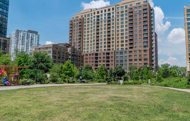 a park in front of some tall buildings