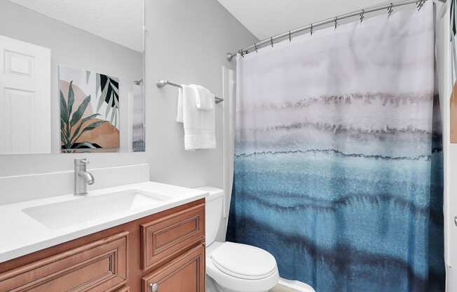 a bathroom with a toilet sink and shower at Stonewater Apartments, Louisville
