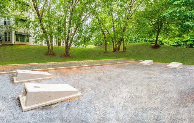 A concrete patio surrounded by trees and grass.