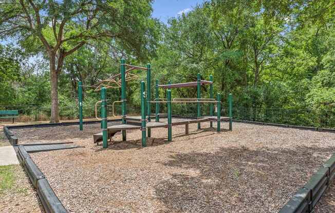 A playground with a swing set and a slide.