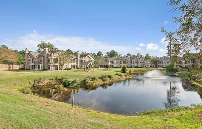 A pond in front of a row of houses.