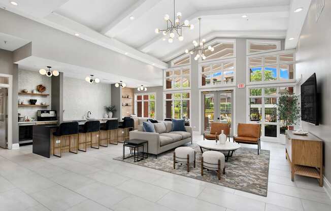 A modern living room with a kitchen area in the background.