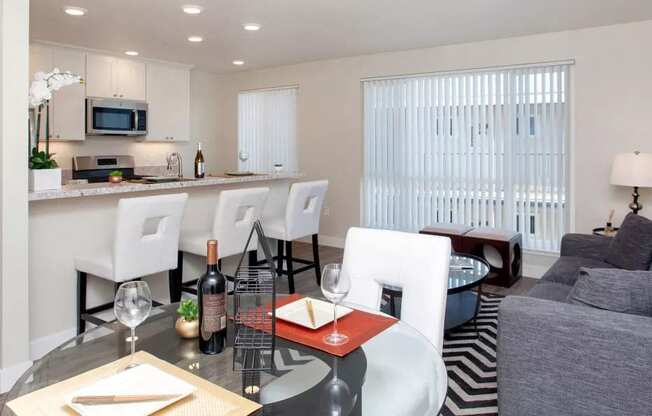 a living room and kitchen with a table and chairs