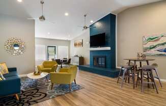a living room with a fireplace and a dining table and chairs