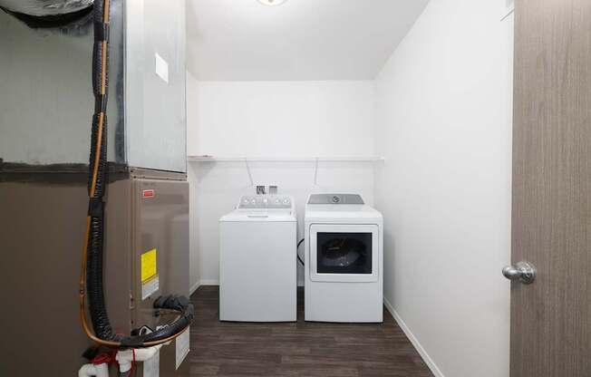 A room with a washing machine and dryer in it.