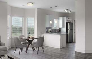 A modern kitchen with a dining table and chairs.