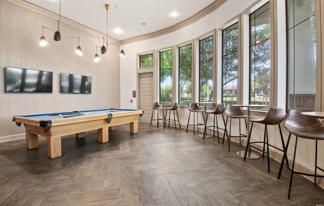 Ample seating in the lounge with a pool table at Mission Gate in Plano TX