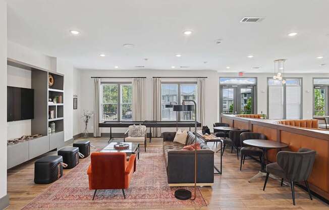 A modern living room with a red chair and a black sofa.