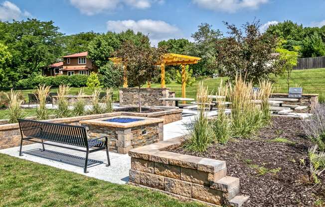 Outdoor picnic area with community grills and fireplaces at Club at Highland Park Apartments, Omaha, NE