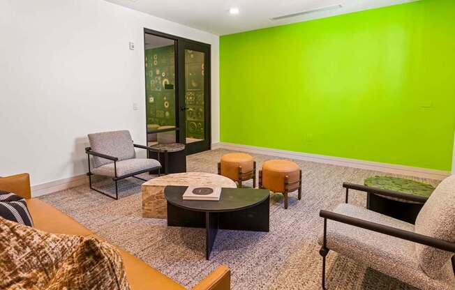 A room with a green wall and a glass door.