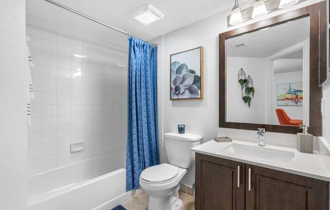 a bathroom with a shower toilet and sink