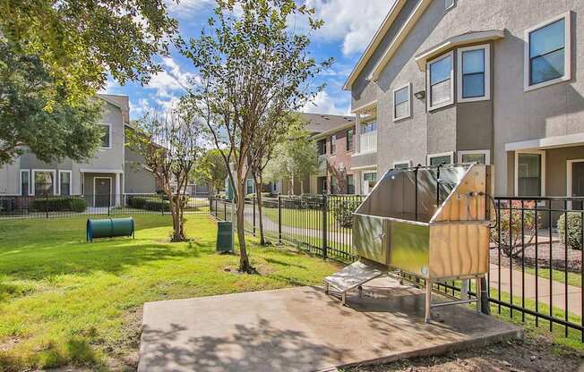 our apartments have a spacious yard with a grill and trees at Sladestone Shadow Creek, Texas, 77584