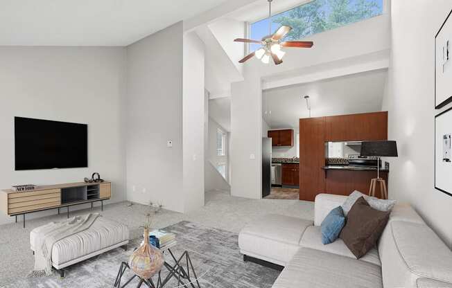 A living room with a white couch and a flat screen TV.