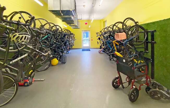 a room filled with lots of bikes and a stroller
