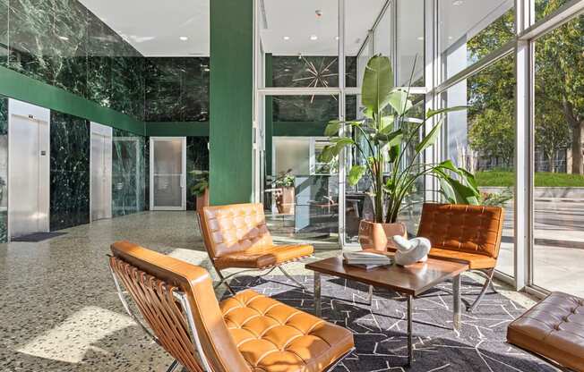 a lobby with leather chairs and a coffee table