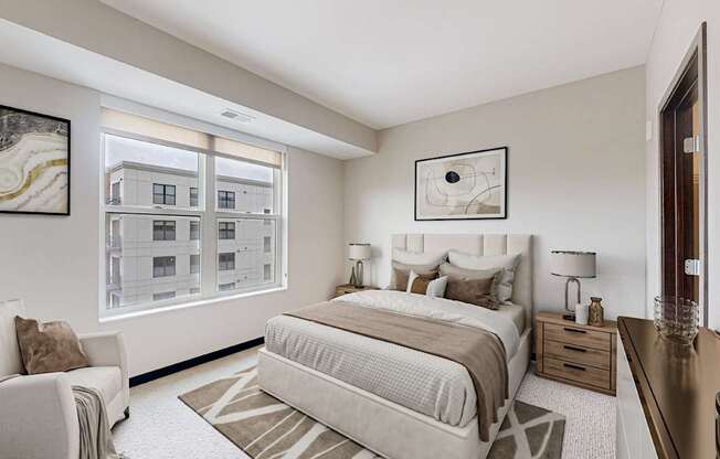 A bedroom with a large bed and a chair.