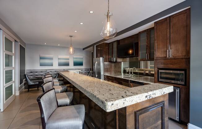 Resident lounge and dining area at our apartments in Alexandria, featuring a granite counter with seating.