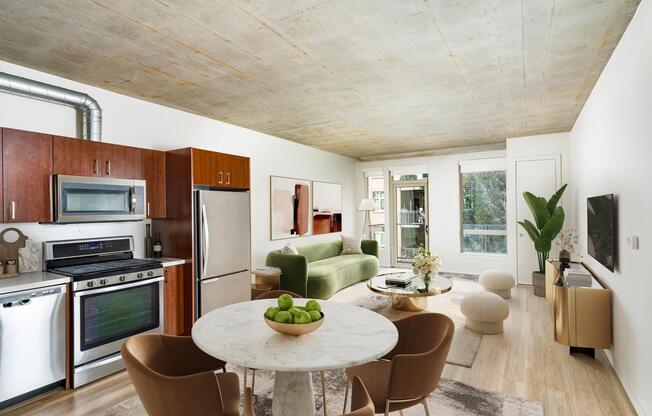 An open apartment home at Modera Pearl with concrete ceilings, warm wood flooring, and flexible living space that adapts easily to your style.