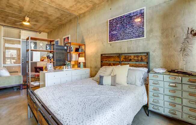 A bedroom with a large bed and a dresser.